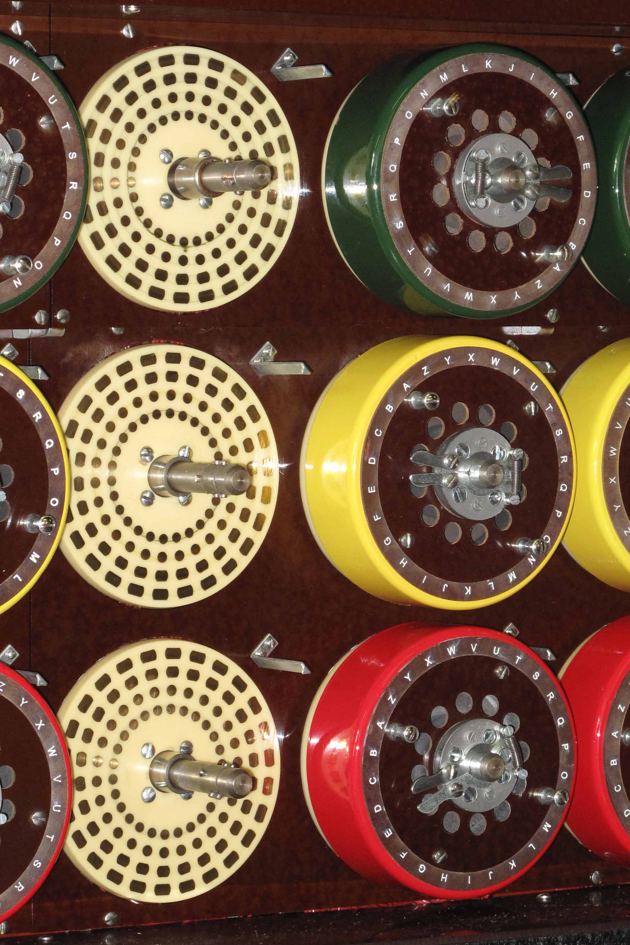 A closeup of 3 red, yellow and green drums on bombe.