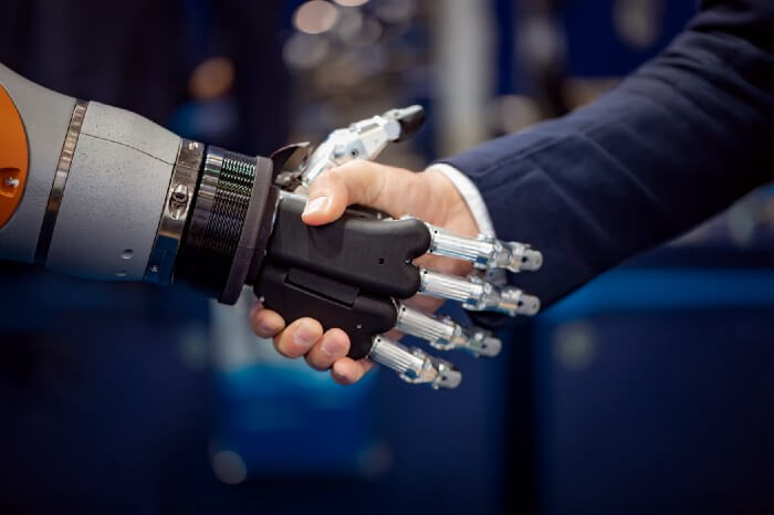 A man shaking hands with a robot